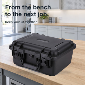 Closed black FR2 hand-carry case by a bright studio exit, with no person shown.